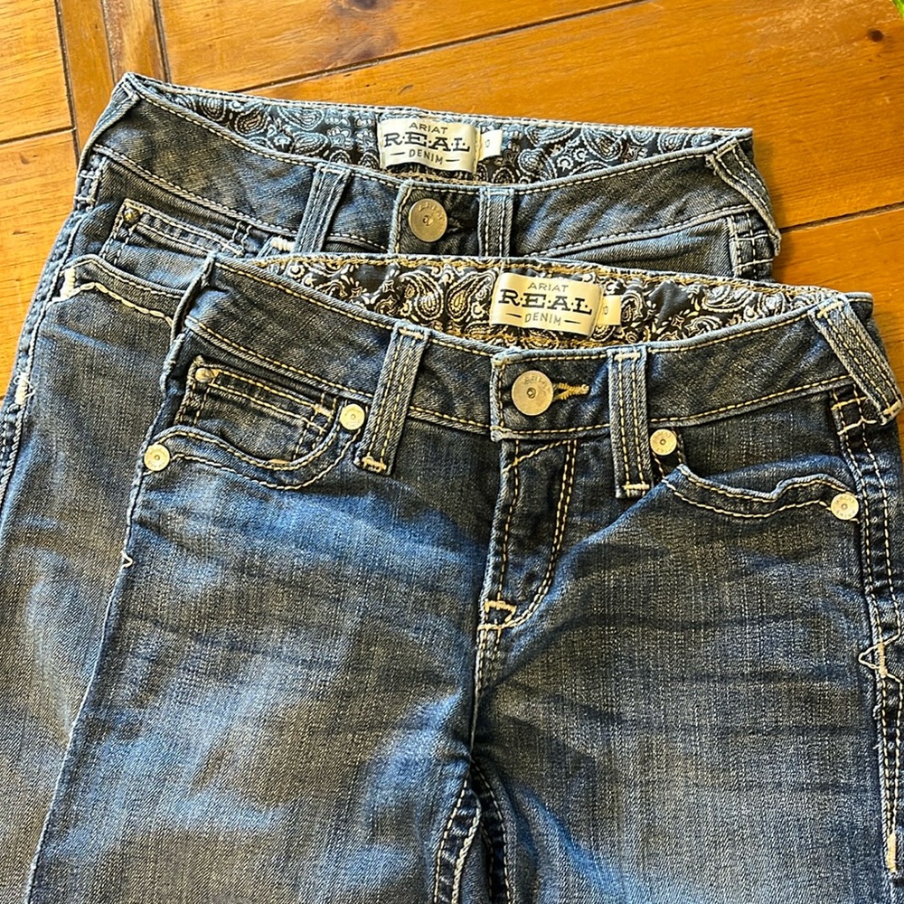 Two pairs of Ariat jeans
